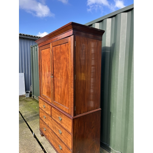 307 - A Victorian mahogany linen press with five slides to the top over five drawer base 136x58x210