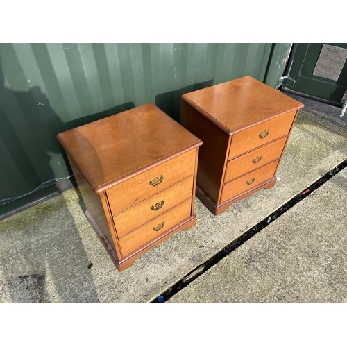 310 - A pair of stag three drawer bedsides