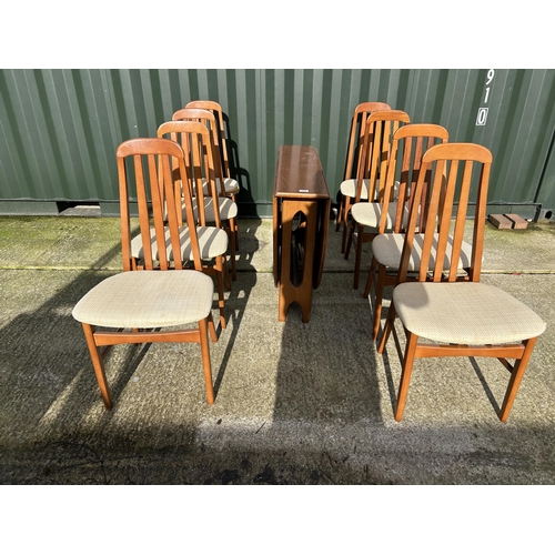 312 - A mid century teak gateleg dining table together with a set of 8 teak high back dining chairs