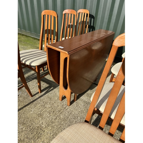 312 - A mid century teak gateleg dining table together with a set of 8 teak high back dining chairs