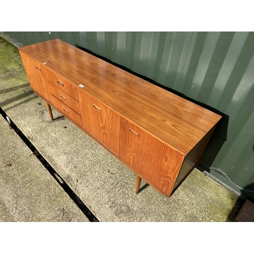 313 - A mid century teak sideboard  183x44x75