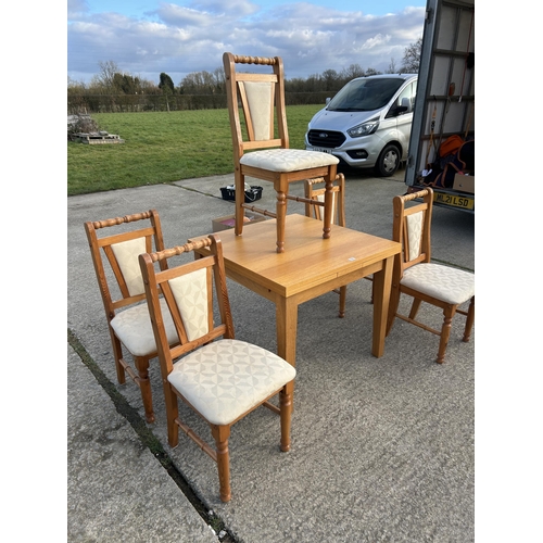 336 - A modern light oak fold over extending dining table together with  five pine dining chairs 90x90