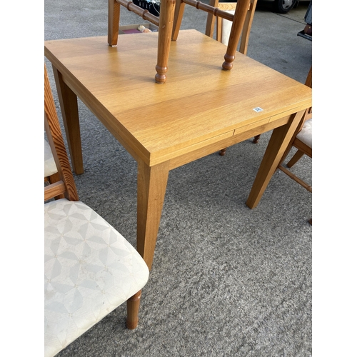 336 - A modern light oak fold over extending dining table together with  five pine dining chairs 90x90