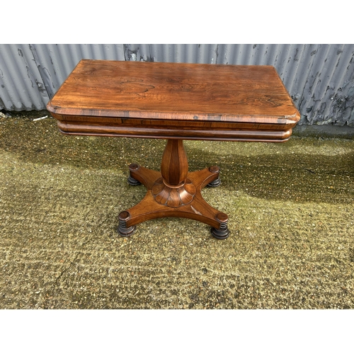 35 - A Victorian rosewood fold over card table with red baize surface