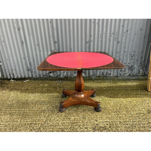 35 - A Victorian rosewood fold over card table with red baize surface