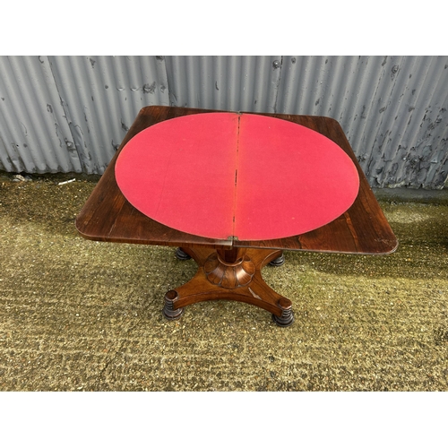 35 - A Victorian rosewood fold over card table with red baize surface