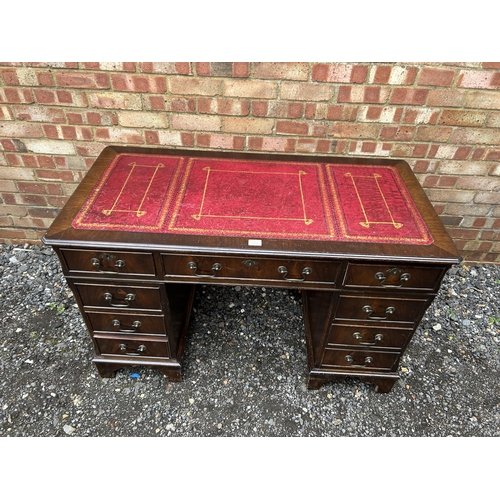 364 - A reproduction mahogany twin pedestal desk with red leather top