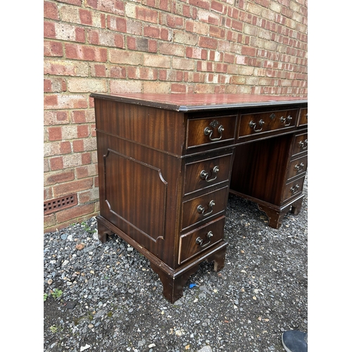 364 - A reproduction mahogany twin pedestal desk with red leather top