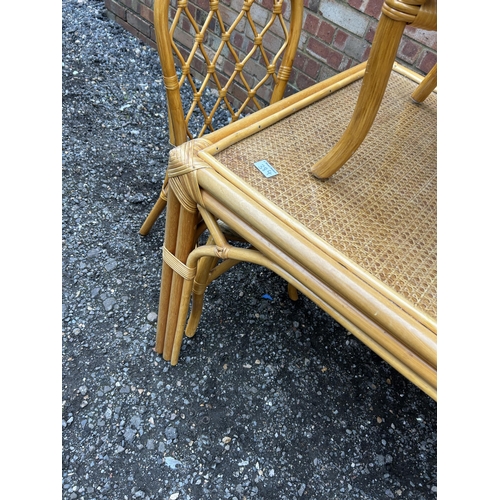 384 - A  vintage style bamboo dining table together with four chairs  136x75