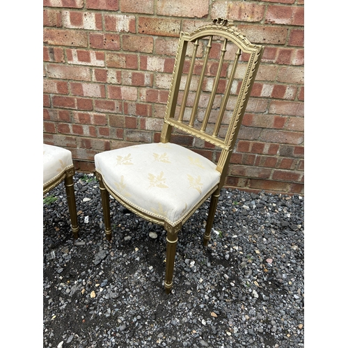 385 - A pair of gold gilt chairs