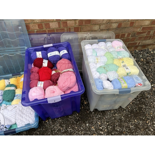 395 - Four large plastic tubs of wool