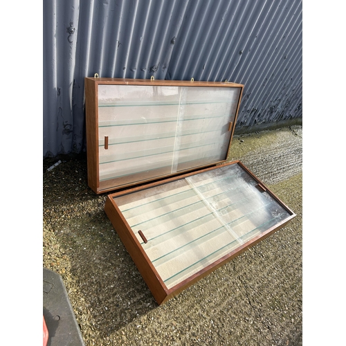 42 - A pair of teak cased collectors wall cabinets with sliding Perspex doors 123x67