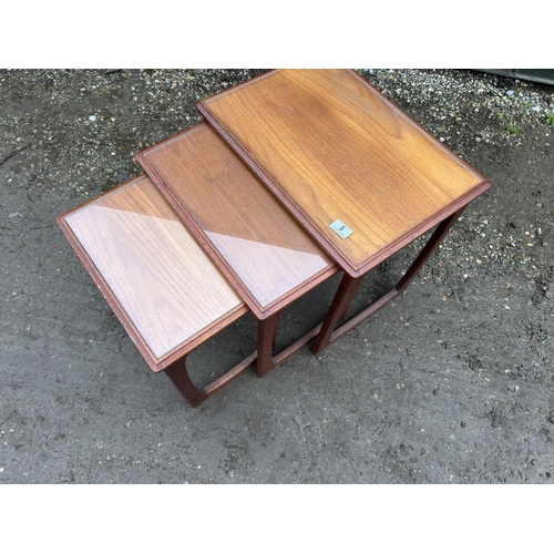 5 - A g plan or similar teak nest of three tables