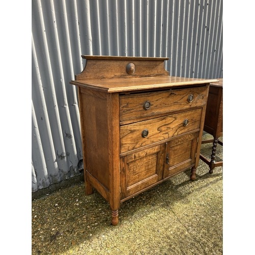 53 - An oak two drawer washstand together with a barley twist cupboard