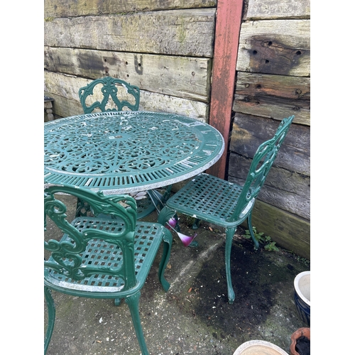 531 - A green painted aluminium garden table and four chair