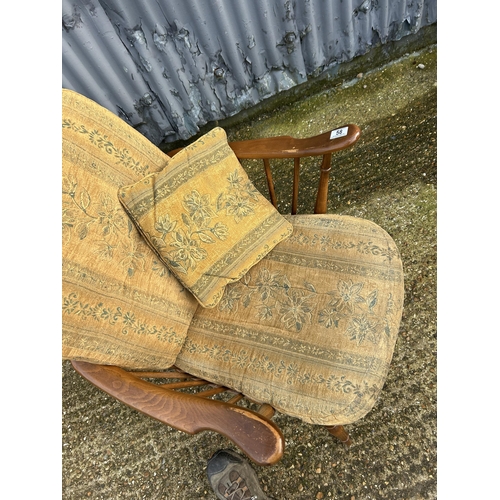 58 - An ercol wheelback armchair