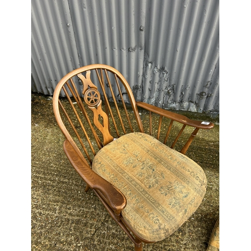 58 - An ercol wheelback armchair