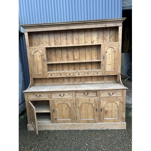 59 - A large antique pine dresser with four drawers and four door base 211x50x225