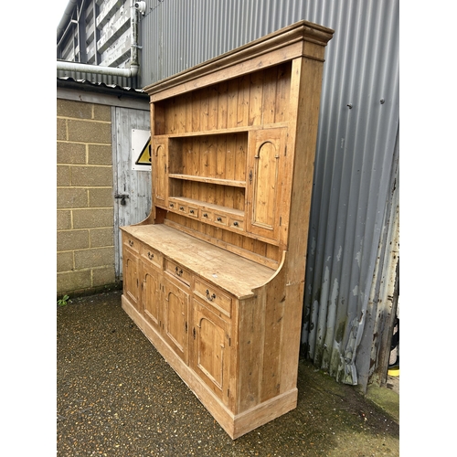 59 - A large antique pine dresser with four drawers and four door base 211x50x225