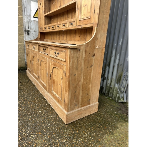 59 - A large antique pine dresser with four drawers and four door base 211x50x225