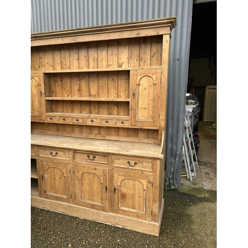 59 - A large antique pine dresser with four drawers and four door base 211x50x225