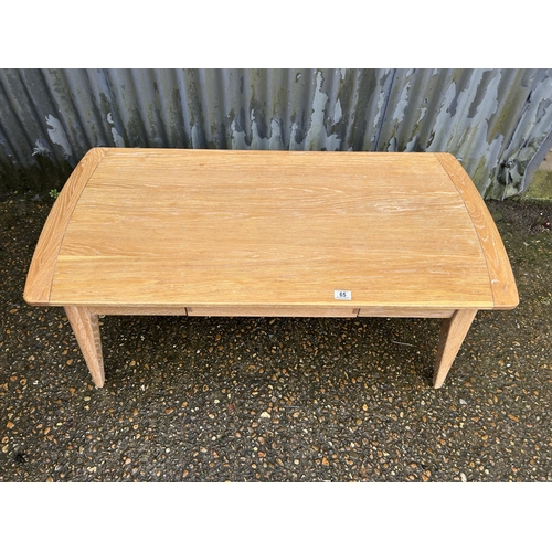 65 - A light oak coffee table with drawer