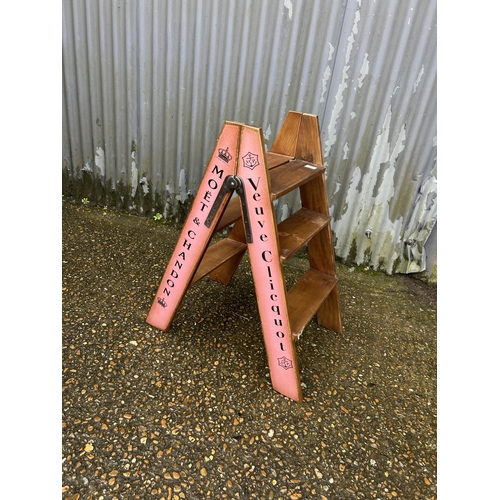 76 - A pair of painted champagne cellar steps marked Veuve Clicquot etc