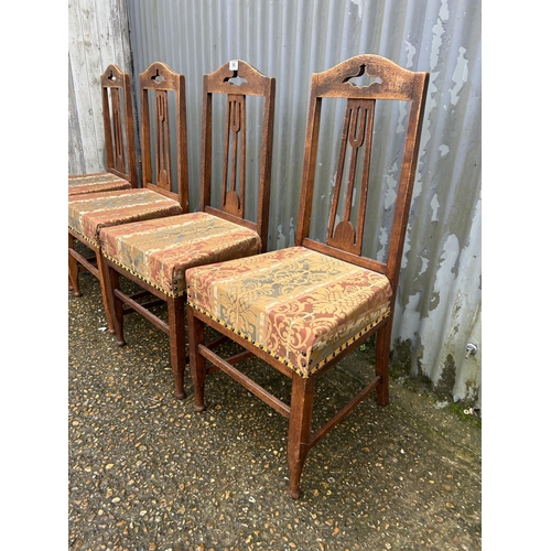 86 - A set of four arts and crafts style oak chairs