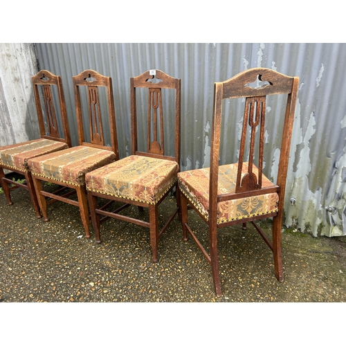 86 - A set of four arts and crafts style oak chairs