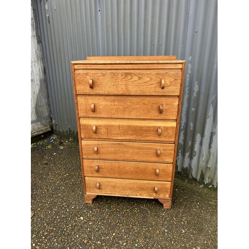 97 - A 20th century oak tallboy chest of six drawers 77x40x125