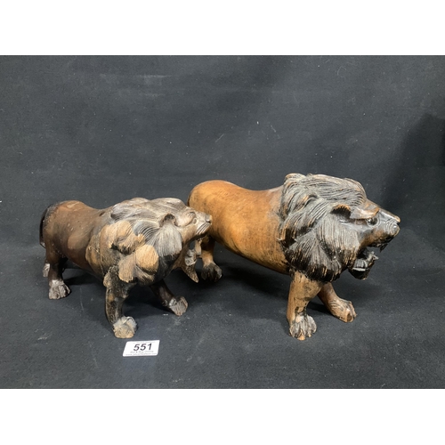 551 - Pair of carved hardwood lions, length 35cms, height 18cms