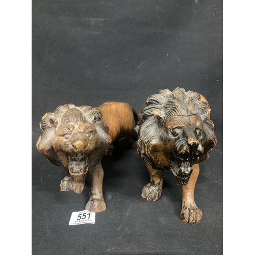 551 - Pair of carved hardwood lions, length 35cms, height 18cms