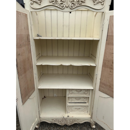 111 - A French style white painted armoire cupboard with part fitted interior  98x56x200