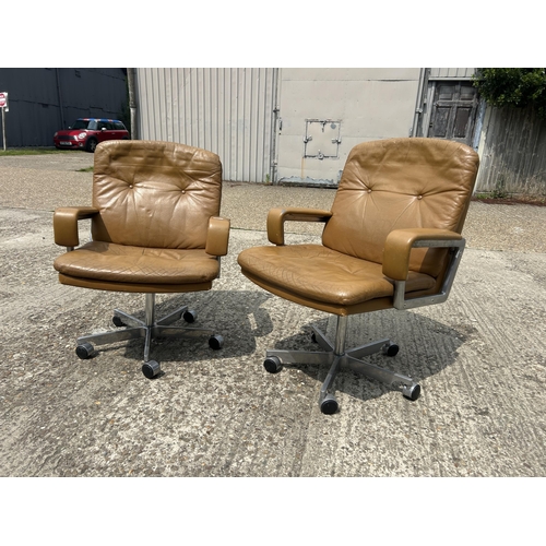 74 - A pair of mid century tan brown swivel desk chairs