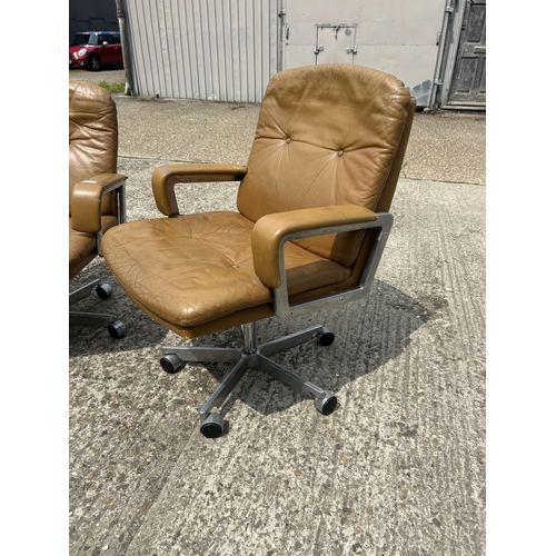 74 - A pair of mid century tan brown swivel desk chairs