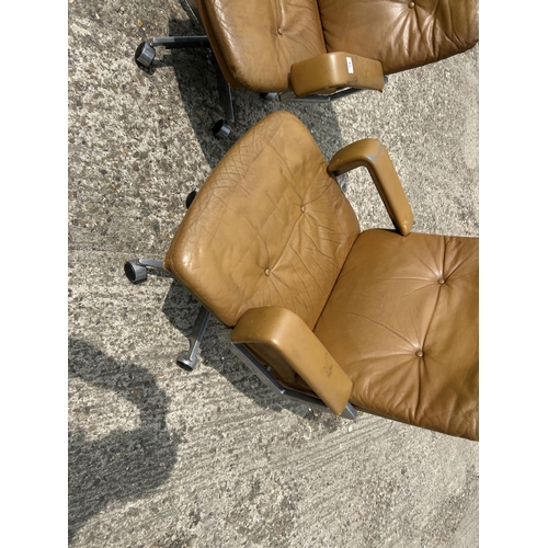 74 - A pair of mid century tan brown swivel desk chairs