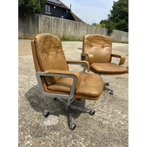 74 - A pair of mid century tan brown swivel desk chairs