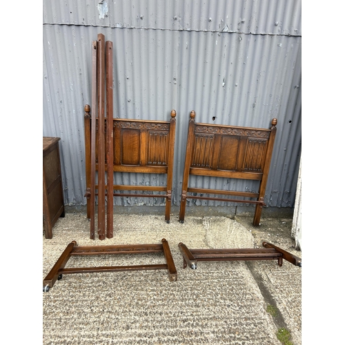91 - A pair of oak linen fold single bed frames