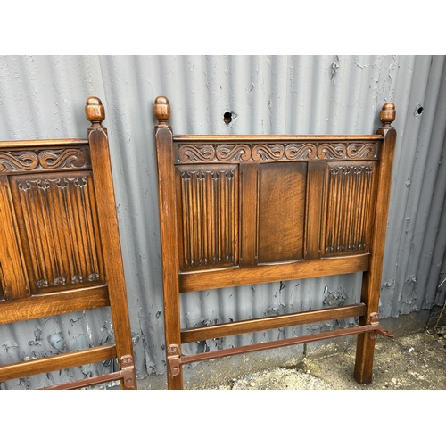 91 - A pair of oak linen fold single bed frames
