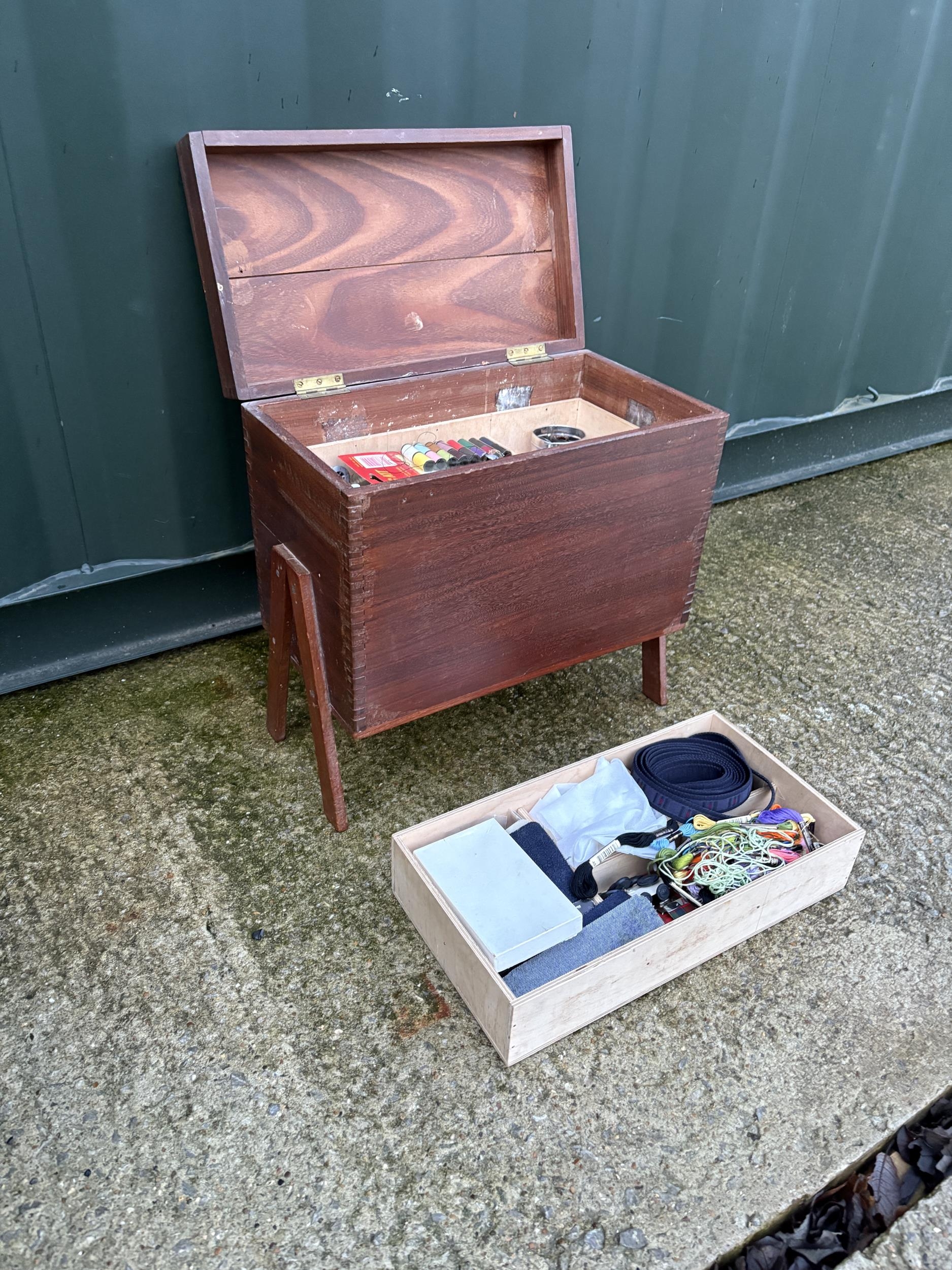 A retro sewing box with contents