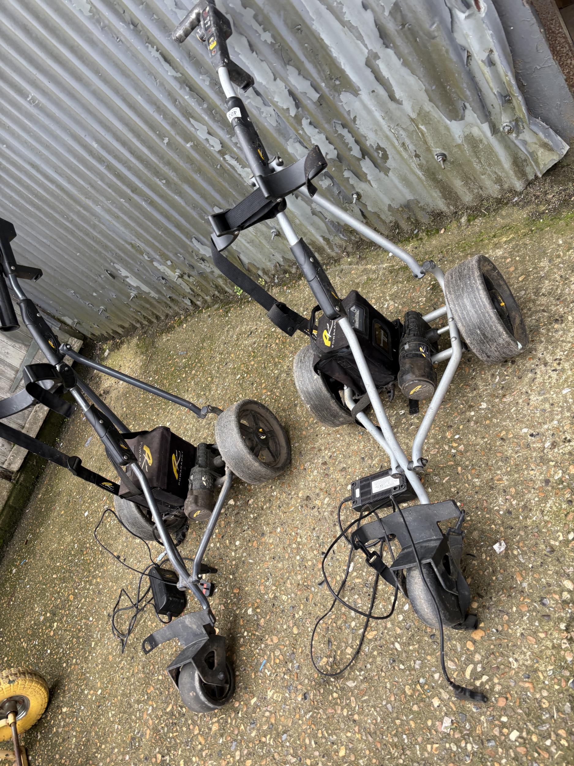 Two power golf caddies with batteries and chargers