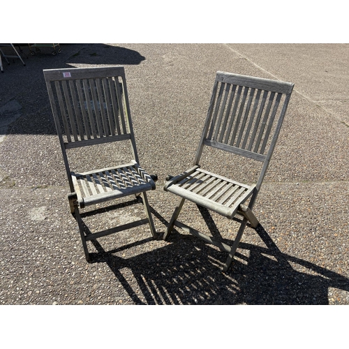 255 - A pair of hardwood folding garden chairs