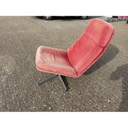 282 - A mid century red upholstered swivel chair on star form base