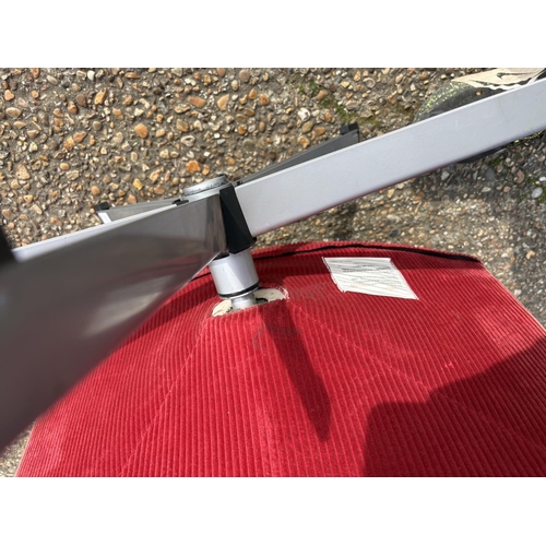 282 - A mid century red upholstered swivel chair on star form base