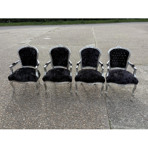 284 - A collection of four silver gilt and black crush velvet throne style armchairs
