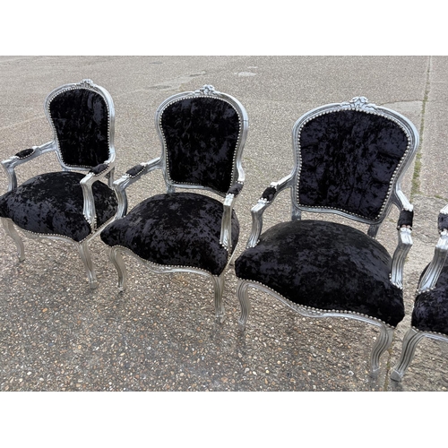 284 - A collection of four silver gilt and black crush velvet throne style armchairs