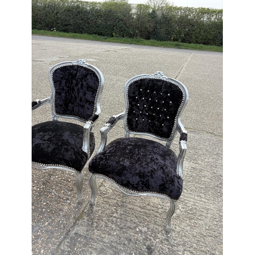 284 - A collection of four silver gilt and black crush velvet throne style armchairs