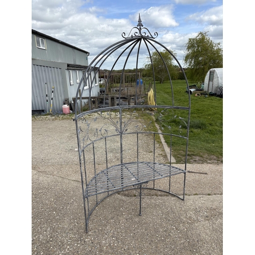 480 - An ornate metal curved garden bench seat with pergola top 135cm wide