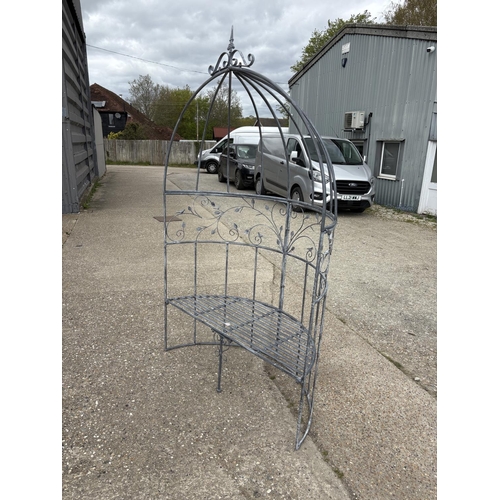 480 - An ornate metal curved garden bench seat with pergola top 135cm wide