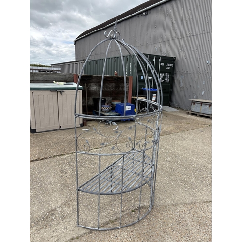 480 - An ornate metal curved garden bench seat with pergola top 135cm wide